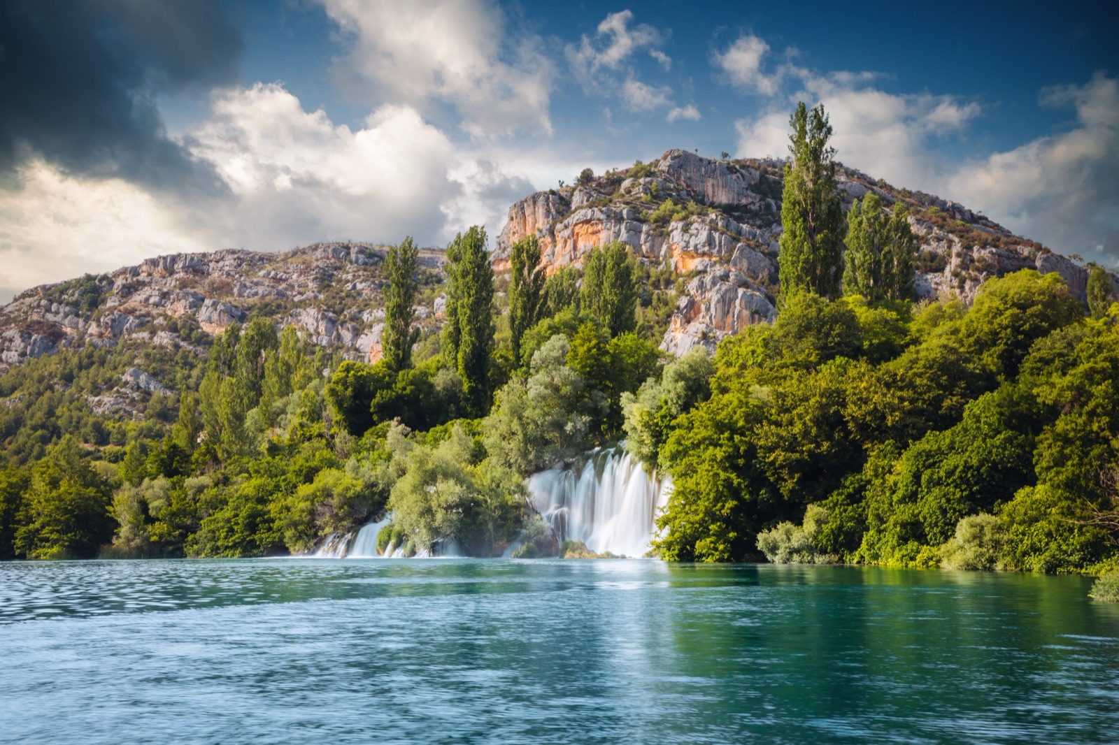 Roški slap waterfall below grey cliffs in Krka National Park